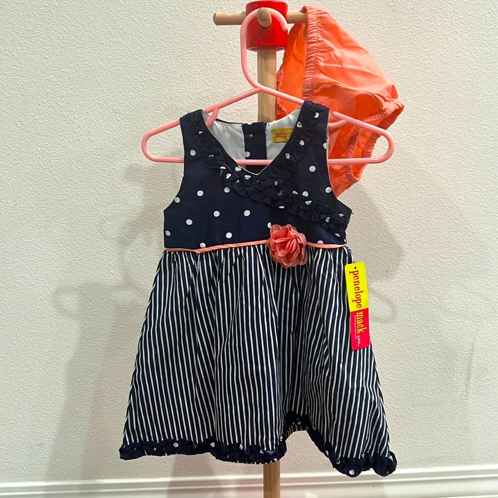 Toddler girl striped and polkadot dress with coral flower in the center